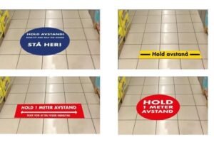 Smart use of vinyl floor graphics for social distancing at grocery store lineup